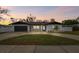 Charming single-story home featuring a well-manicured lawn, fresh exterior paint, and a dark two-car garage at 1621 S Keene Rd, Clearwater, FL 33756