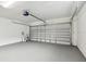 A spacious garage with a white garage door and gray flooring at 1621 S Keene Rd, Clearwater, FL 33756
