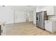 Spacious kitchen with stainless steel refrigerator, sleek white cabinetry, and plenty of storage space at 1621 S Keene Rd, Clearwater, FL 33756