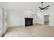 Inviting living room featuring light wood floors, a decorative fireplace, and an abundance of natural light at 1621 S Keene Rd, Clearwater, FL 33756