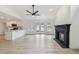 Open floor plan featuring new light wood flooring, a fireplace, and a remodeled kitchen with an island at 1621 S Keene Rd, Clearwater, FL 33756
