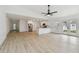 Open concept living space with light wood flooring, a kitchen with an island, and stainless steel appliances at 1621 S Keene Rd, Clearwater, FL 33756