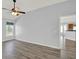 Open bedroom with hardwood floors and view to kitchen, with a ceiling fan at 1665 Bonita Bluff Ct, Ruskin, FL 33570