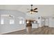 Bright living area with wood flooring open to the kitchen with views of the backyard at 1665 Bonita Bluff Ct, Ruskin, FL 33570
