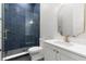 Stylish bathroom with a glass-enclosed shower, blue tiling, and a vanity sink at 216 N Hesperides St, Tampa, FL 33609