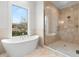 Bathroom with a soaking tub in front of a window and glass door shower at 216 N Hesperides St, Tampa, FL 33609