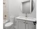 Bright bathroom with a large oval mirror, marble countertop, and tiled shower at 216 N Hesperides St, Tampa, FL 33609