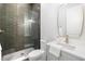 Modern bathroom features a glass-enclosed shower, stylish fixtures, and contemporary vanity at 216 N Hesperides St, Tampa, FL 33609