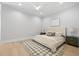 Bright bedroom features a plush bed, neutral decor, and hardwood floors at 216 N Hesperides St, Tampa, FL 33609