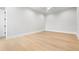 Empty bedroom with light wood flooring, base trim, and white ceiling fan at 216 N Hesperides St, Tampa, FL 33609