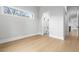 Sunlit bedroom offering wood floors and views into an attached bathroom and hallway at 216 N Hesperides St, Tampa, FL 33609