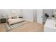 Bright and modern bedroom featuring hardwood floors, neutral decor, and soft natural light at 216 N Hesperides St, Tampa, FL 33609