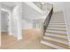 Bright foyer featuring wood-look tile floors, a staircase, and a neutral color palette at 216 N Hesperides St, Tampa, FL 33609