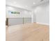Open hallway featuring hardwood floors, a modern railing, and natural light at 216 N Hesperides St, Tampa, FL 33609