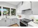 Well-lit kitchen with a view and featuring modern appliances, sleek countertops, and ample cabinet space at 216 N Hesperides St, Tampa, FL 33609