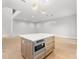 Spacious kitchen island with stainless steel microwave in an open-concept floor plan at 216 N Hesperides St, Tampa, FL 33609