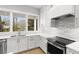 Updated kitchen featuring modern appliances, white cabinets, and quartz countertops at 216 N Hesperides St, Tampa, FL 33609