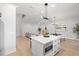 Bright, open-concept kitchen features a center island, modern lighting, and seamless flow into the living area at 216 N Hesperides St, Tampa, FL 33609