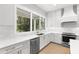 Modern kitchen with white cabinets, stainless steel appliances, and bright lighting at 216 N Hesperides St, Tampa, FL 33609