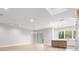 Open living area with wood-look tile floors, modern lighting, and sliding glass doors at 216 N Hesperides St, Tampa, FL 33609