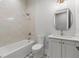 Bathroom featuring white tile and vanity with shower and tub combination at 222 N Hesperides St, Tampa, FL 33609