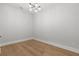 An empty bedroom featuring wood floors and a modern ceiling light fixture at 222 N Hesperides St, Tampa, FL 33609