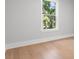 An empty bedroom with hardwood floors, neutral colored walls and a window with natural light at 222 N Hesperides St, Tampa, FL 33609
