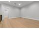 Bonus room features sleek ceiling fan, hardwood floors, and neutral color palette at 222 N Hesperides St, Tampa, FL 33609