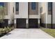 Beautiful modern home exterior showcasing a two-car garage and lush landscaping around a long driveway at 222 N Hesperides St, Tampa, FL 33609