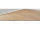 Close up of the hardwood flooring and white base trim at 222 N Hesperides St, Tampa, FL 33609