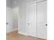 Bright hallway featuring hardwood floors, white trim, and a double door closet at 222 N Hesperides St, Tampa, FL 33609