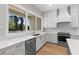 Bright kitchen featuring stainless steel appliances, white cabinets, and large window with an exterior view at 222 N Hesperides St, Tampa, FL 33609