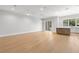 Open floor plan with hardwood floors and bright lighting, showcasing the spacious living area with sliding door at 222 N Hesperides St, Tampa, FL 33609