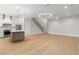 Open floor plan showing kitchen with island, stainless appliances, and staircase from the living area at 222 N Hesperides St, Tampa, FL 33609