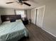Bedroom with wood-look floors, ceiling fan, and closet at 2344 Tahitian Dr, Holiday, FL 34691