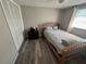 Charming bedroom features laminate floors, a dresser, and a closet at 2344 Tahitian Dr, Holiday, FL 34691
