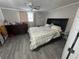 This cozy bedroom features a ceiling fan, a dresser, and neutral decor at 2344 Tahitian Dr, Holiday, FL 34691