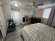 This bedroom is well-lit with a fan, dresser, and built in cabinets at 2344 Tahitian Dr, Holiday, FL 34691