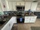 Cozy kitchen featuring granite countertops and stainless steel appliances at 2344 Tahitian Dr, Holiday, FL 34691