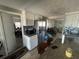 Functional kitchen boasting white cabinetry, stainless steel appliances, and a view to living areas at 2344 Tahitian Dr, Holiday, FL 34691