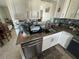 Well-lit kitchen with stainless steel dishwasher and dark backsplash at 2344 Tahitian Dr, Holiday, FL 34691