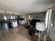 Spacious living room and kitchen area with tiled flooring and natural light at 2344 Tahitian Dr, Holiday, FL 34691