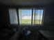 Inviting living room with large windows and verdant backyard views at 2344 Tahitian Dr, Holiday, FL 34691