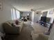 Spacious living room with a ceiling fan, lots of light, and tile floors at 2344 Tahitian Dr, Holiday, FL 34691