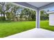 Lush backyard with a sprawling green lawn, mature trees, offering a peaceful and private outdoor space at 2497 Orange Harvest Pl, Seffner, FL 33584