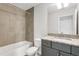 Tiled bathroom with shower and granite vanity, offering style and functionality at 2497 Orange Harvest Pl, Seffner, FL 33584