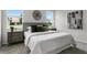Relaxing bedroom with white bedding, stylish decor, and large windows offering natural light at 2497 Orange Harvest Pl, Seffner, FL 33584