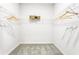 Walk-in closet featuring shelving for optimal storage with neutral carpet at 2497 Orange Harvest Pl, Seffner, FL 33584