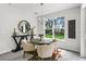 Cozy dining area featuring a round table, modern decor, and a large window overlooking the backyard at 2497 Orange Harvest Pl, Seffner, FL 33584