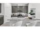 Modern kitchen with granite countertops, stainless steel appliances, and a breakfast bar with seating at 2497 Orange Harvest Pl, Seffner, FL 33584